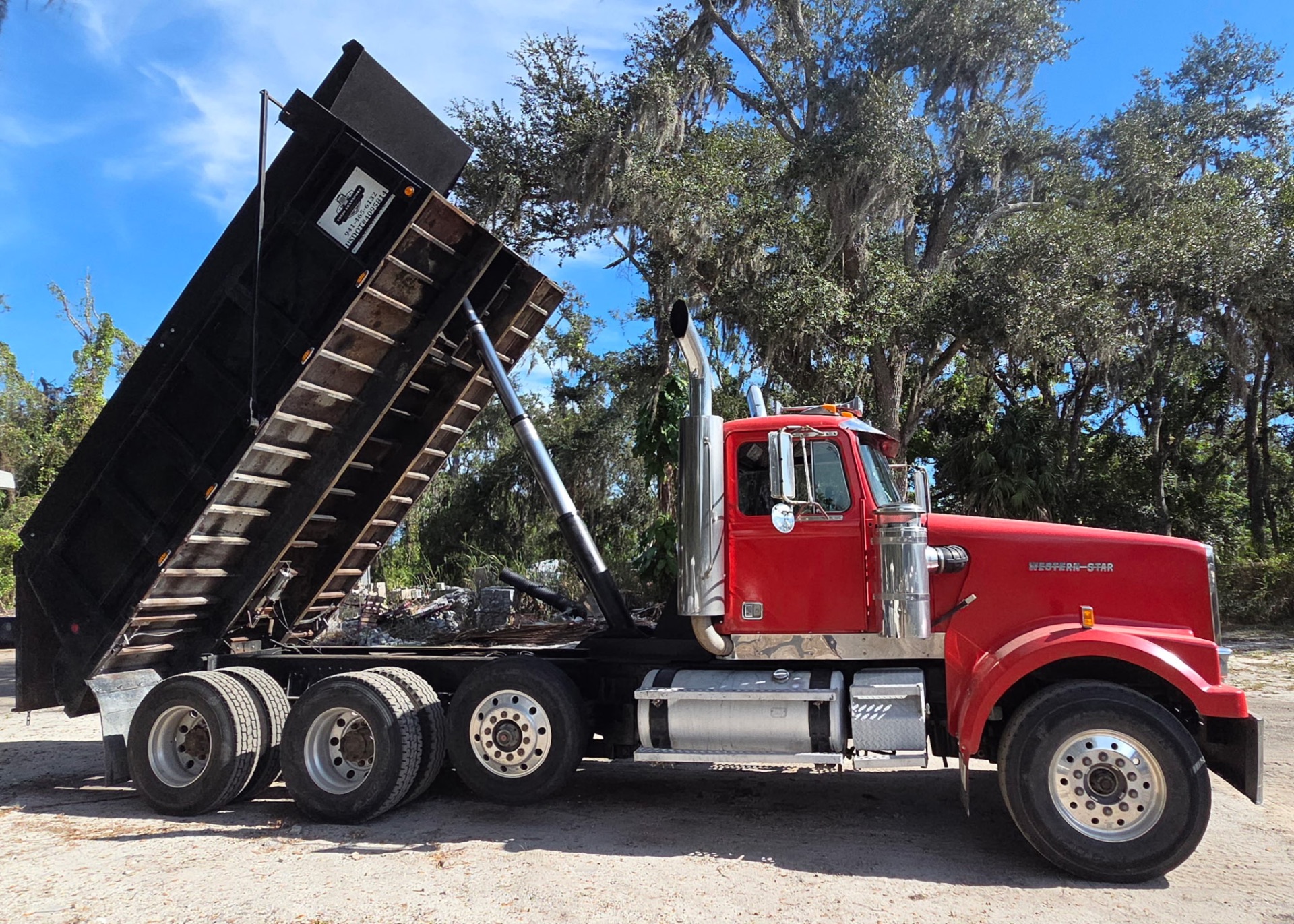 Red dump truck at Bradenton construction site