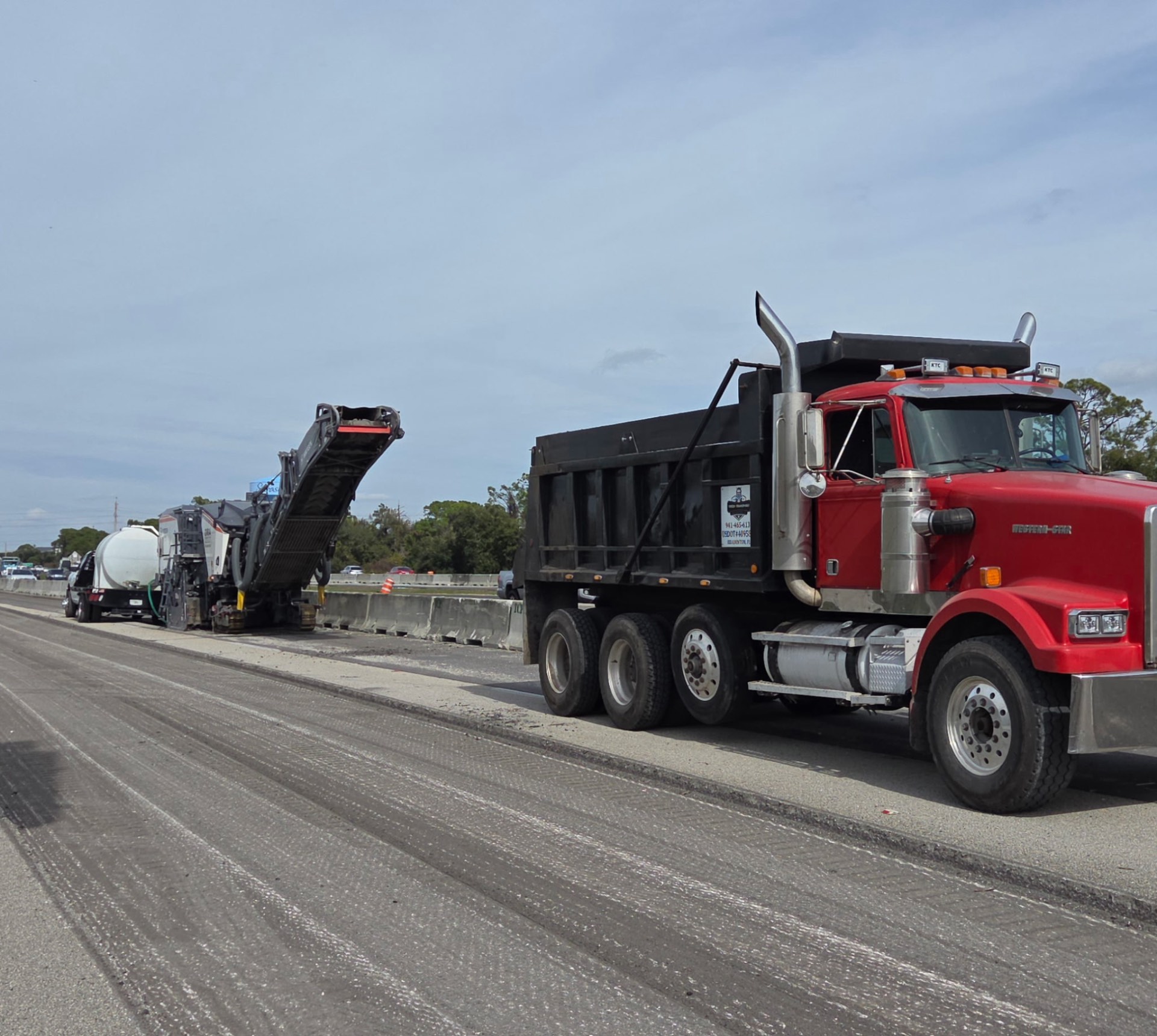 Trejo Transport red dump truck on Florida highway asphalt milling job